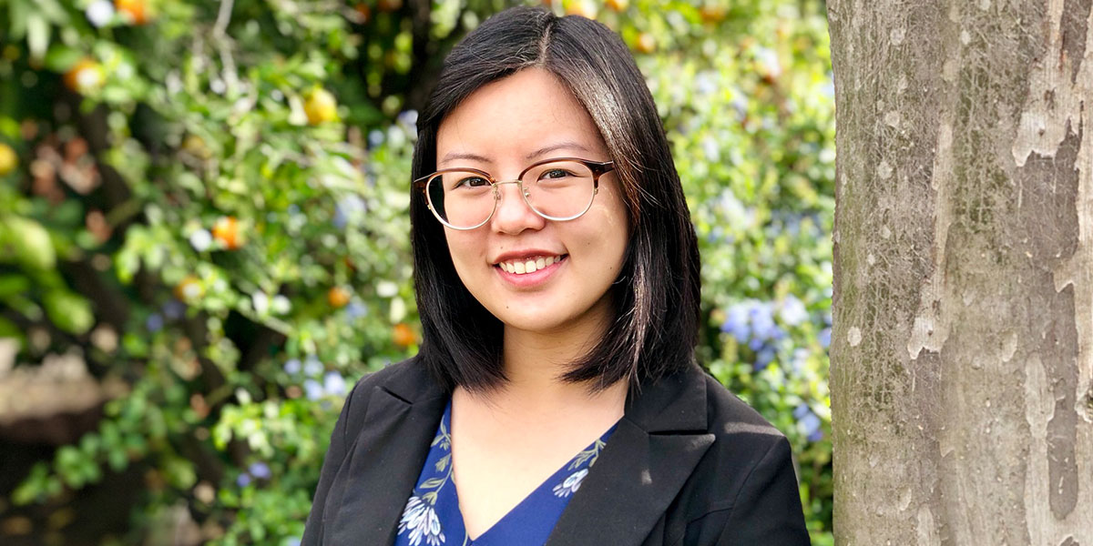 Ashley Yu posing in front of a tree
